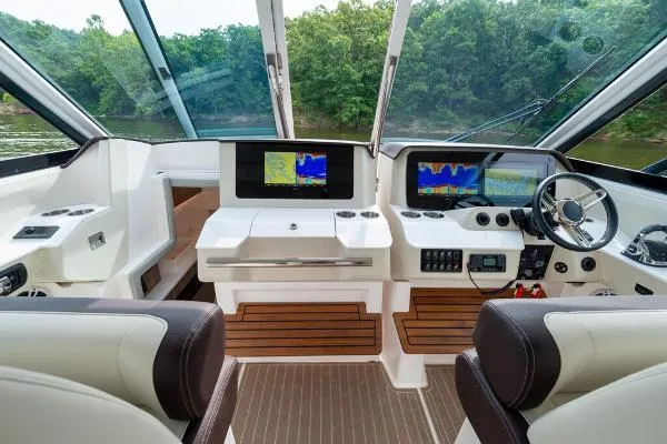 Slide: The Image of 2023 Regal LS36 boat cockpit with modern navigation displays and luxurious seating. - 11