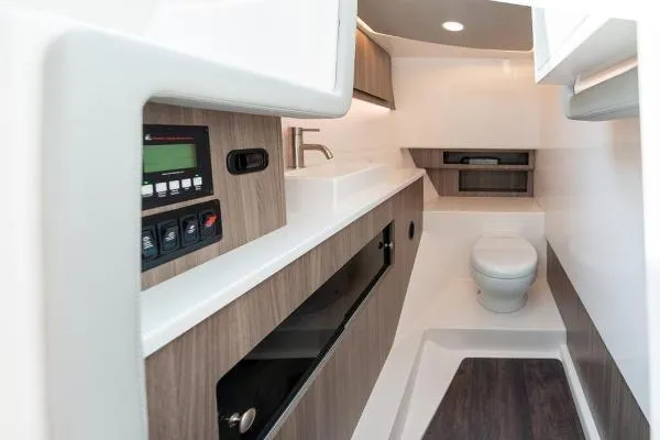 Slide: The Image of 2023 Regal LS36 boat interior with modern bathroom and control panel. - 12