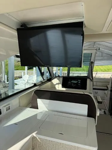 Slide: The Image of 2023 Regal LS36 boat interior with modern dashboard and mounted screen. - 13