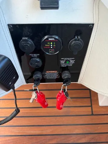 Slide: The Image of Control panel of 2023 Regal LS36 boat with keys and switches. - 14