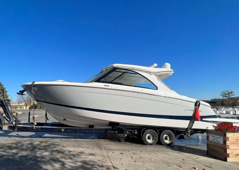Slide: The Image of 2023 Regal LS36 boat on a trailer under a clear blue sky. - 21