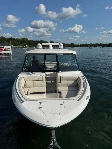 Slide: The Image of 2023 Regal LS36 boat on a lake under a clear blue sky. - 6