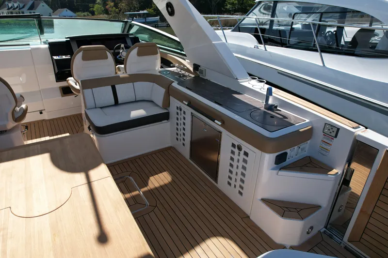 Slide: The Image of 2019 Sea Ray SLX 400 boat interior with beige and white seating. - 21