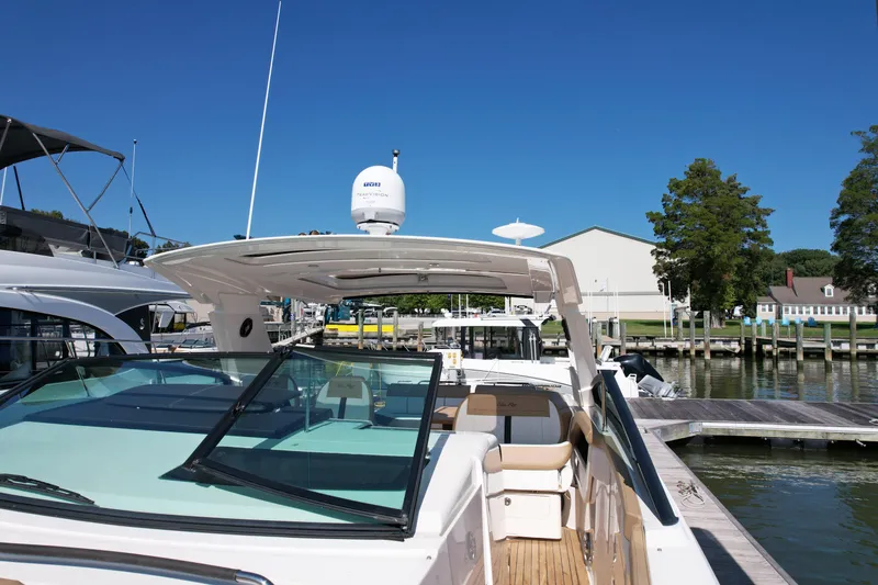 Slide: The Image of 2019 Sea Ray SLX 400 boat with retractable sunroof at marina. - 28