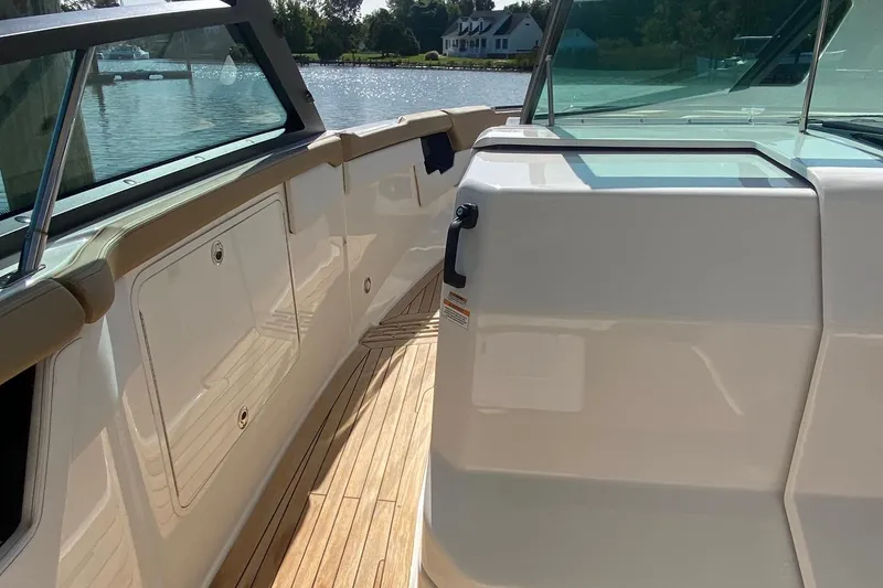 Slide: The Image of Luxurious 2019 Sea Ray SLX 400 yacht interior with elegant seating and wooden table. - 32