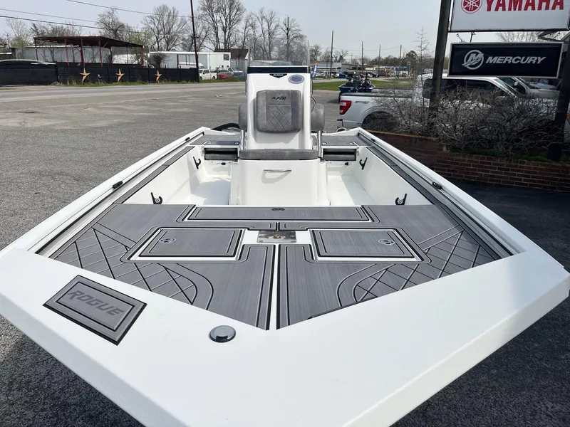 Slide: The Image of 2024 Avid 20 Rogue boat with sleek deck design, displayed at a dealership. - 6