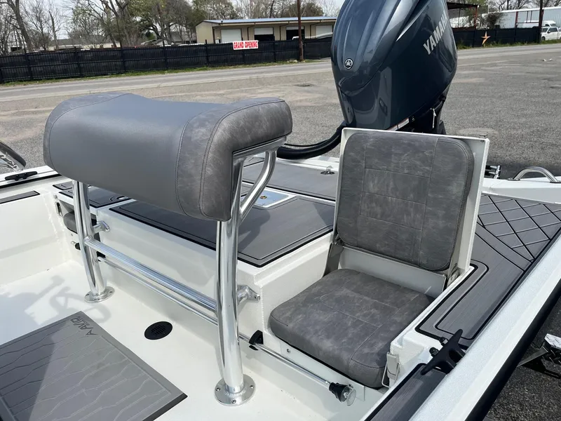Slide: The Image of 2024 Avid 20 Rogue boat interior with gray seating and Yamaha outboard motor. - 8