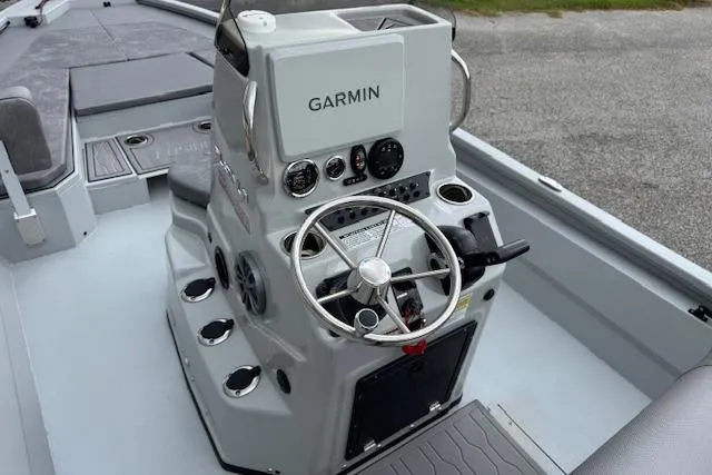 Slide: The Image of 2024 Avid 23 Fusion boat console with Garmin navigation system and steering wheel. - 10