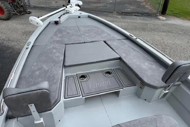 Slide: The Image of 2024 Avid 23 Fusion boat interior with gray seating and storage compartments. - 12