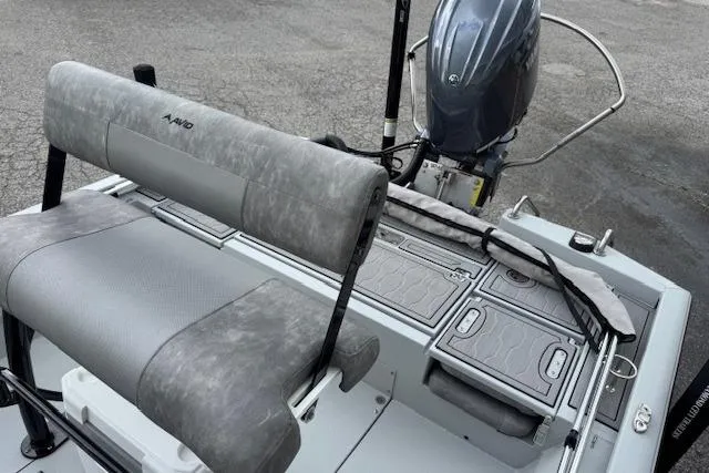 Slide: The Image of 2024 Avid 23 Fusion boat interior with gray seating and motor. - 13
