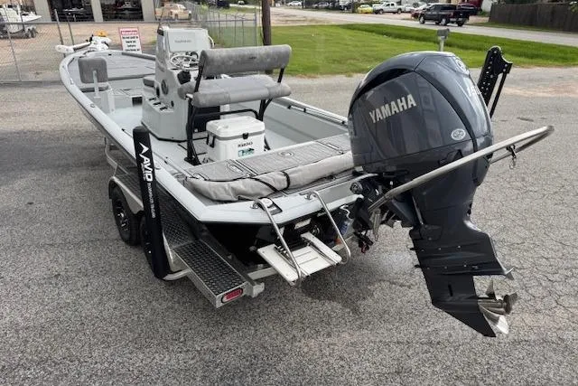 Slide: The Image of 2024 Avid 23 Fusion boat with Yamaha outboard motor on a trailer. - 4