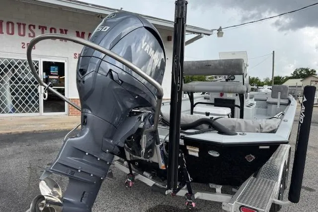 Slide: The Image of 2024 Avid 23 Fusion boat with Yamaha engine on trailer, parked outside a building. - 8