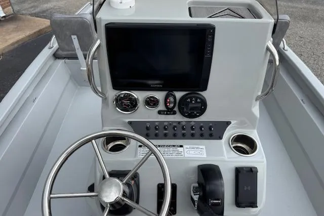 Slide: The Image of 2024 Avid 23 Fusion boat console with steering wheel, gauges, and navigation screen. - 9