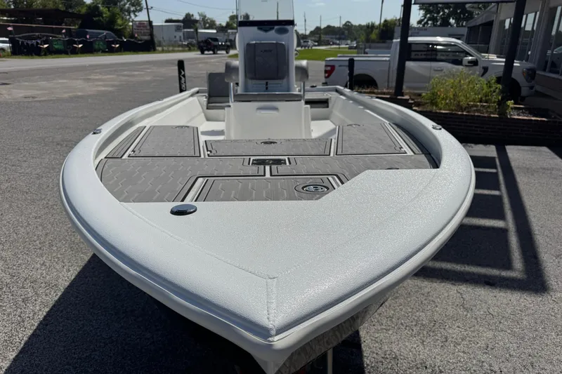 Slide: The Image of 2024 Avid 23 Mag boat, sleek design, parked outdoors on a sunny day. - 10