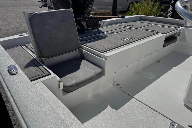 Slide: The Image of 2024 Avid 23 Mag boat interior with cushioned seating and storage compartments. - 12