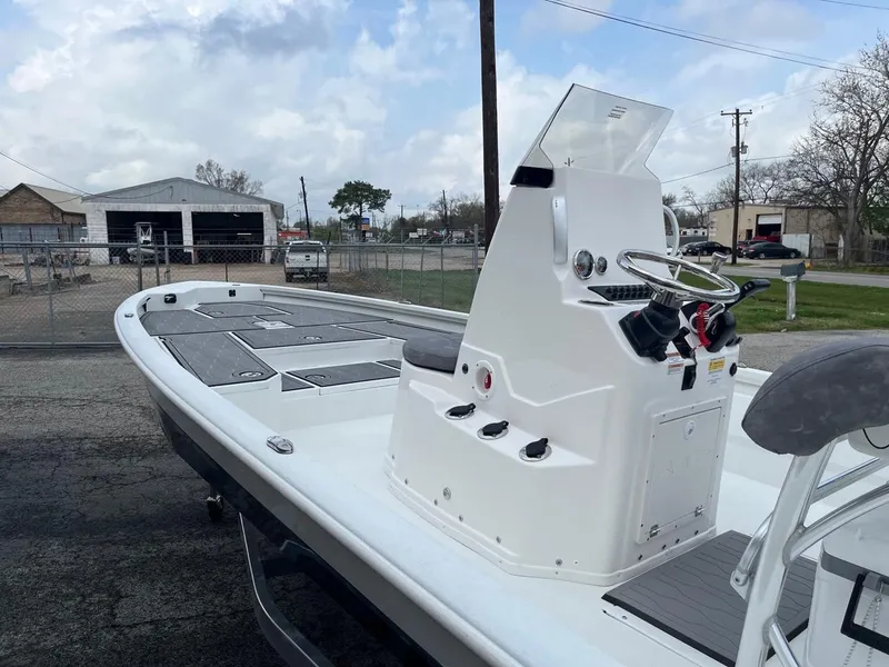 Slide: The Image of 2024 Avid 23 Mag boat with center console in a parking lot. - 3
