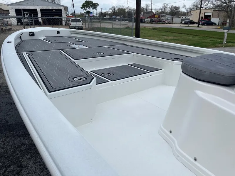 Slide: The Image of 2024 Avid 23 Mag boat deck with storage compartments and seating. - 8