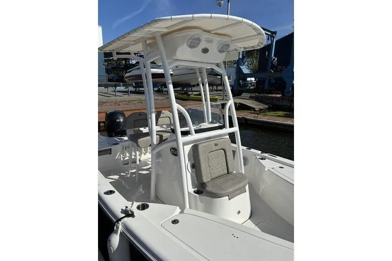 Slide: The Image of 2023 Sea Pro 208 Bay boat with T-top and seating, docked in marina. - 11