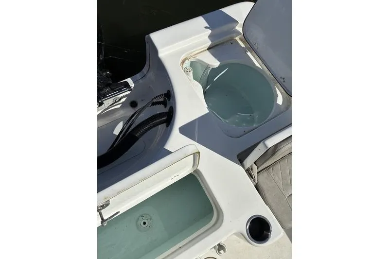 Slide: The Image of 2023 Sea Pro 208 Bay boat deck with storage compartments and cup holder. - 12