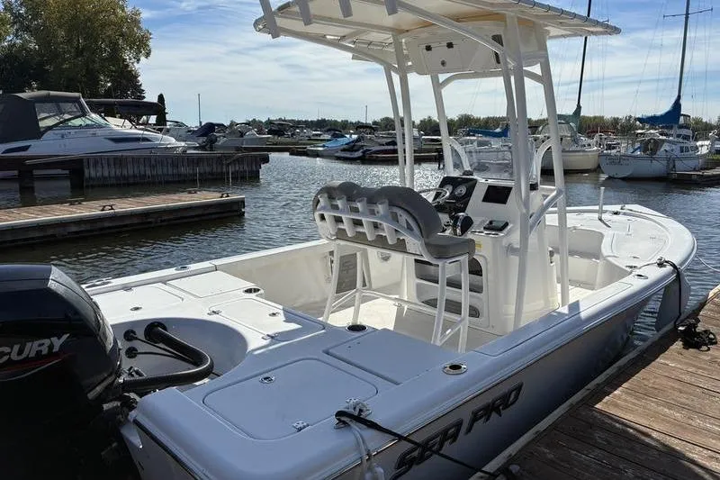 Slide: The Image of 2023 Sea Pro 208 Bay boat docked at marina, featuring sleek design and modern amenities. - 14