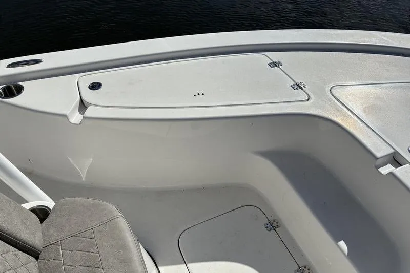 Slide: The Image of 2023 Sea Pro 208 Bay boat interior with storage compartments and seating. - 15
