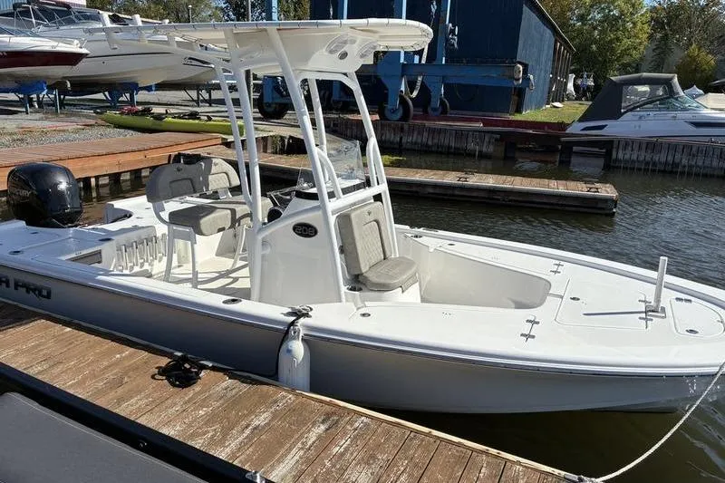 Slide: The Image of 2023 Sea Pro 208 Bay boat docked at a marina, featuring a sleek design. - 17