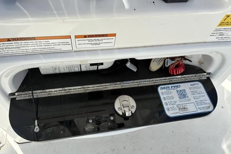 Slide: The Image of 2023 Sea Pro 208 Bay boat compartment with safety warnings and equipment. - 22