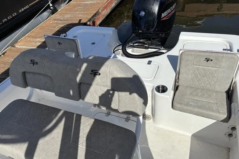 Slide: The Image of 2023 Sea Pro 208 Bay boat interior with gray seating and Mercury engine. - 26