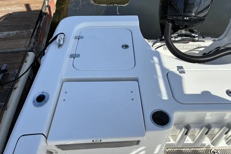 Slide: The Image of 2023 Sea Pro 208 Bay boat stern with motor and storage compartments. - 28