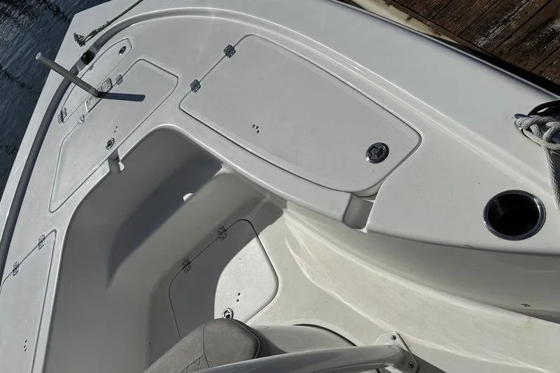 Slide: The Image of 2023 Sea Pro 208 Bay boat interior with storage compartments and seating. - 31