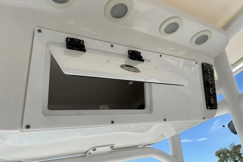 Slide: The Image of 2023 Sea Pro 208 Bay boat storage compartment with open hatch and control panel. - 33