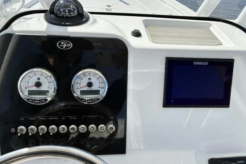 Slide: The Image of 2023 Sea Pro 208 Bay boat dashboard with gauges and Simrad display. - 39