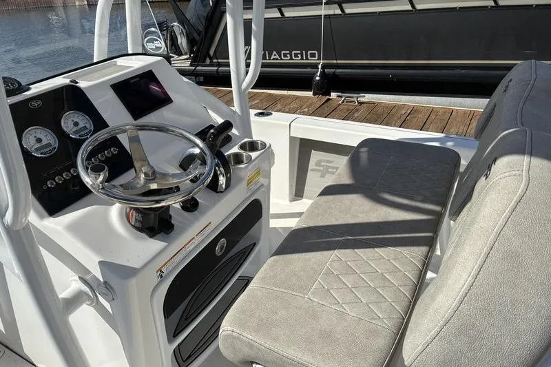 Slide: The Image of 2023 Sea Pro 208 Bay boat interior with steering console and cushioned seating. - 40