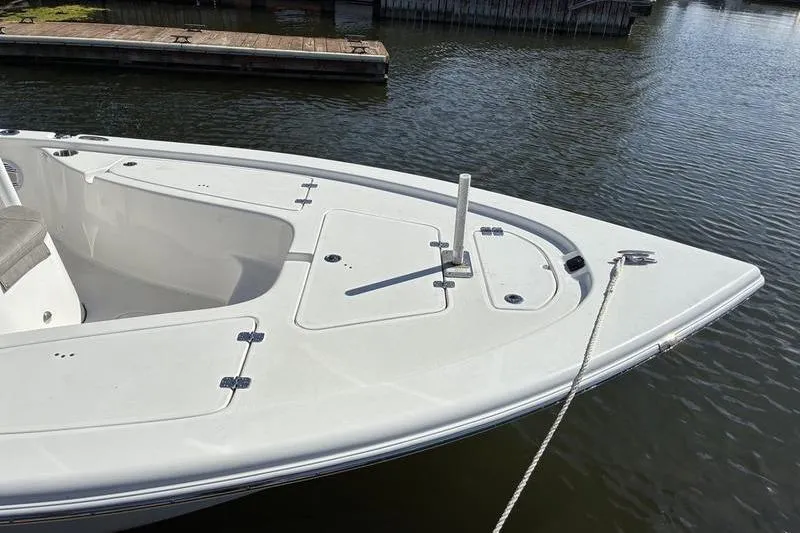 Slide: The Image of 2023 Sea Pro 208 Bay boat docked on calm water. - 42