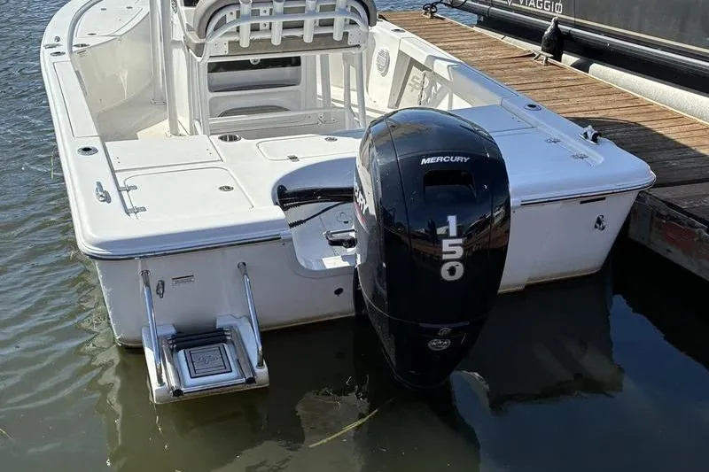 Slide: The Image of 2023 Sea Pro 208 Bay boat with Mercury 150 engine docked in water. - 43