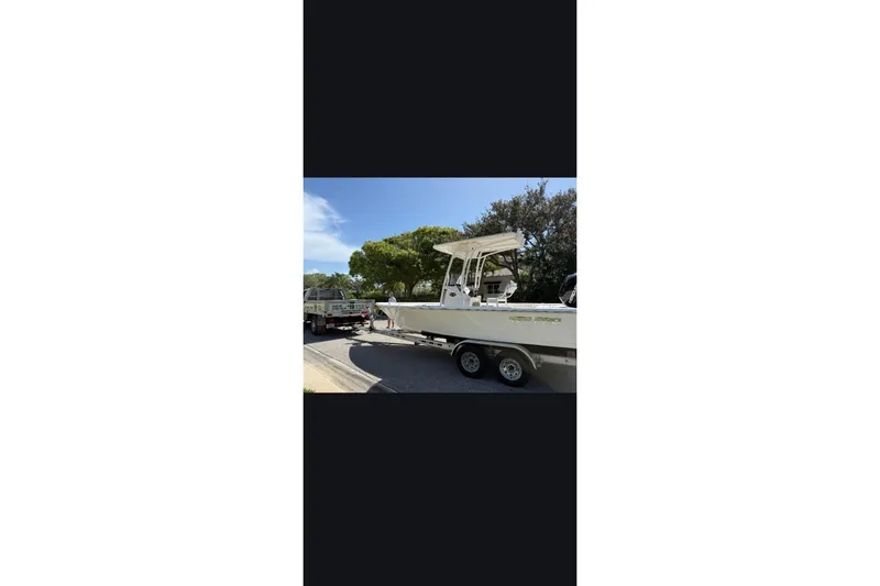 Slide: The Image of 2023 Sea Pro 208 Bay boat on trailer, sunny day. - 7