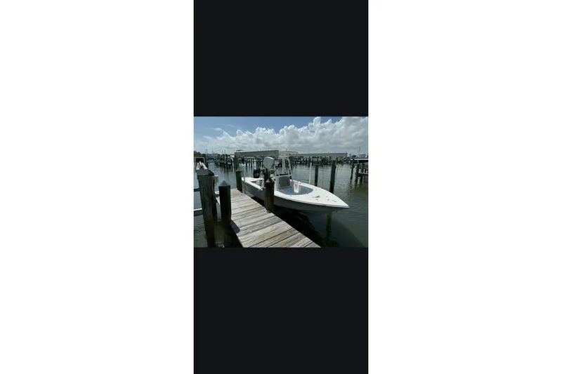 Slide: The Image of 2023 Sea Pro 208 Bay boat docked on a sunny day. - 8