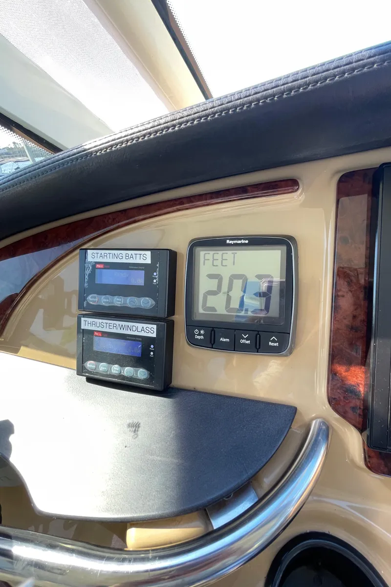 Slide: The Image of Carver 506 Motor Yacht 2001 dashboard with depth gauge and battery indicators. - 16