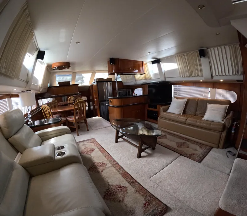 Slide: The Image of Interior of 2001 Carver 506 Motor Yacht with luxurious seating and dining area. - 25