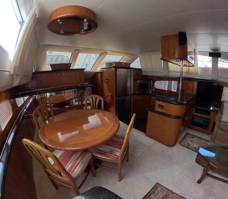Slide: The Image of Interior of 2001 Carver 506 Motor Yacht with dining area and kitchen. - 28