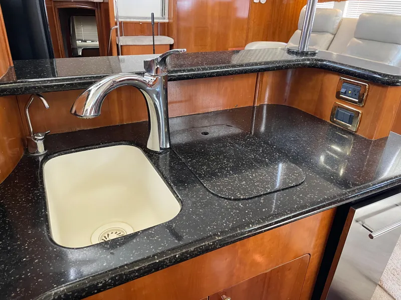 Slide: The Image of 2001 Carver 506 Motor Yacht kitchen sink and counter area with modern fixtures. - 33