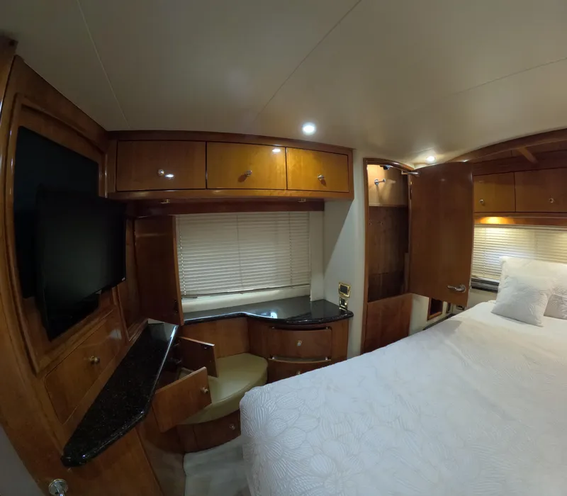 Slide: The Image of Luxurious bedroom interior of 2001 Carver 506 Motor Yacht with wood cabinetry and modern amenities. - 39