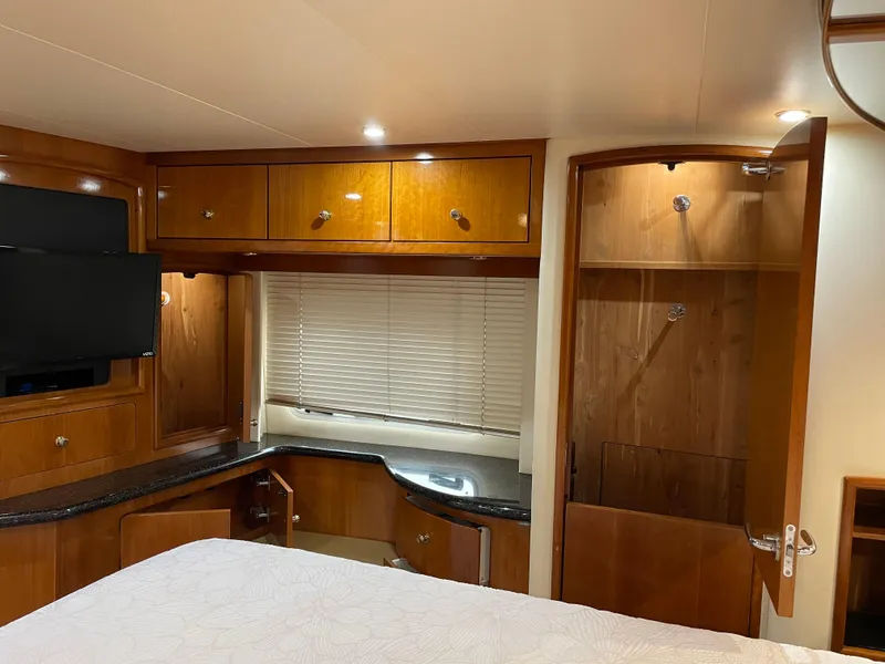 Slide: The Image of Interior of 2001 Carver 506 Motor Yacht with wood cabinetry and TV. - 41