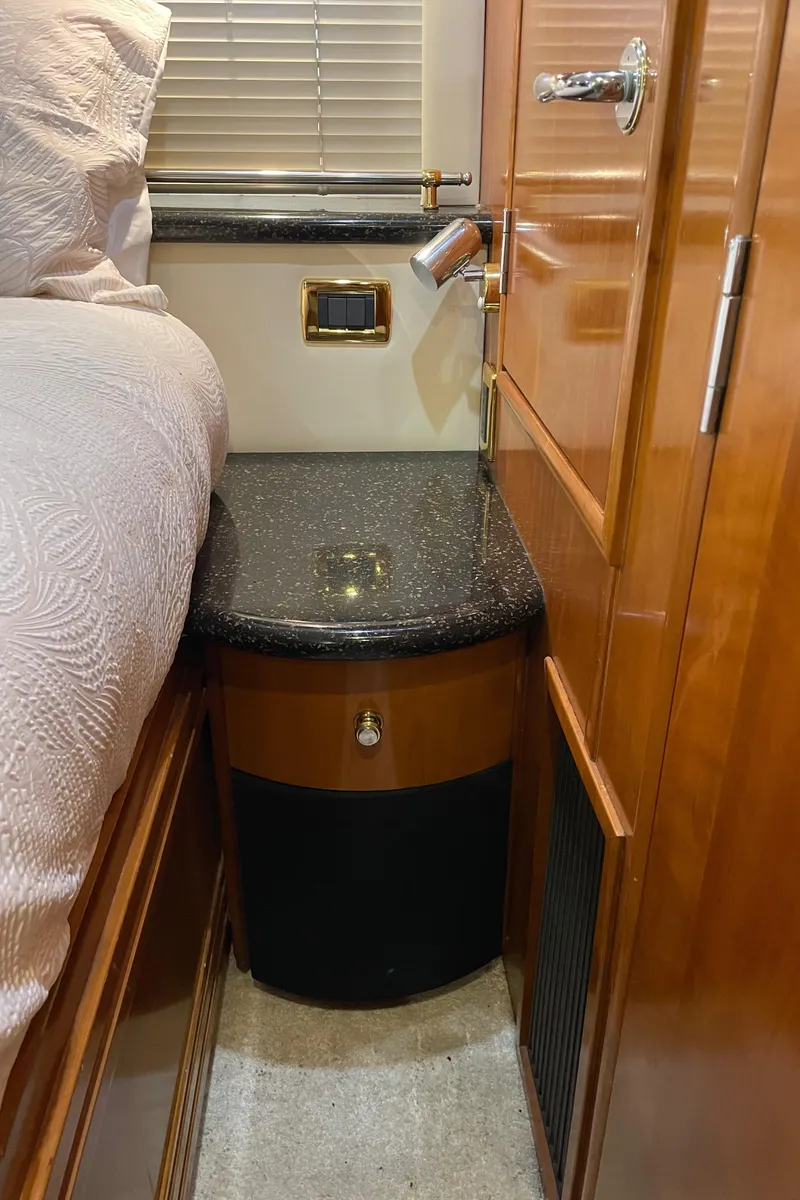 Slide: The Image of 2001 Carver 506 Motor Yacht interior with wooden cabinetry and granite countertop. - 44