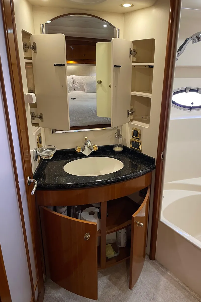 Slide: The Image of 2001 Carver 506 Motor Yacht bathroom with vanity and storage cabinets. - 49