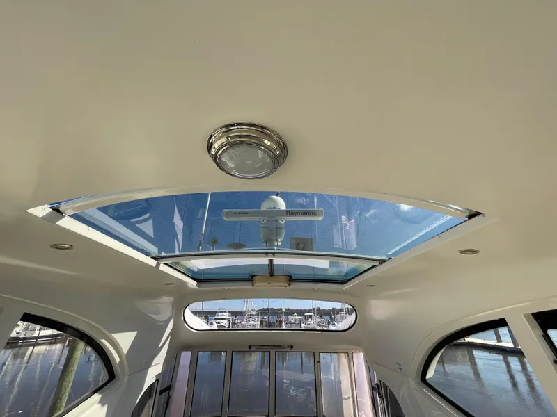 Slide: The Image of Interior view of 2001 Carver 506 Motor Yacht with skylight and marina background. - 9