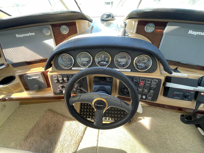 Slide: The Image of 2001 Carver 506 Motor Yacht helm with Raymarine electronics and control panel. - 10