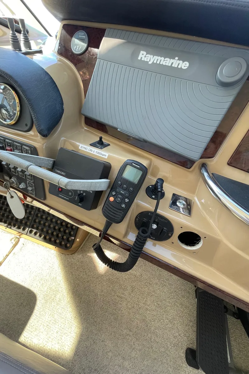 Slide: The Image of 2001 Carver 506 Motor Yacht helm with Raymarine navigation system and communication equipment. - 13