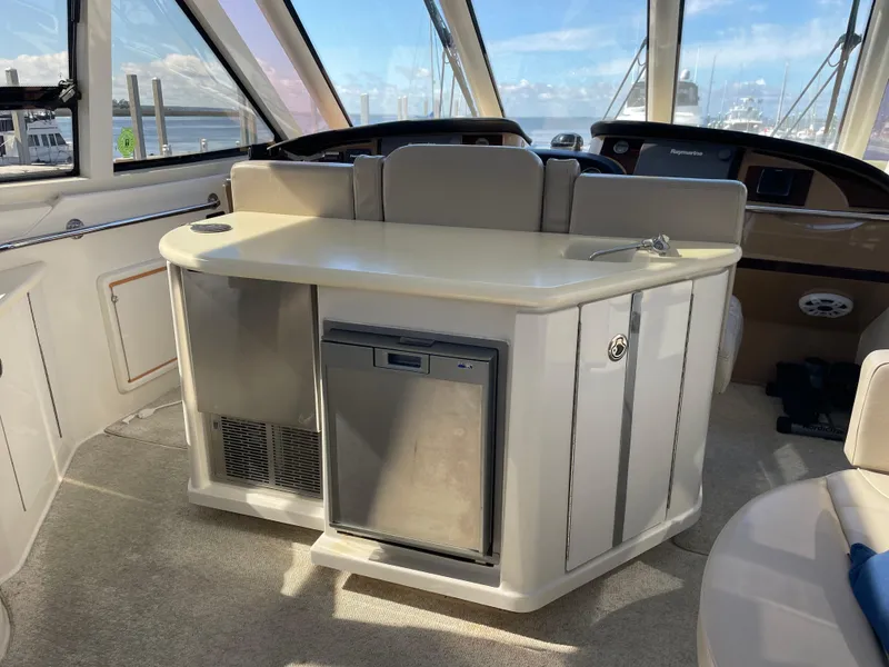 Slide: The Image of 2001 Carver 506 Motor Yacht interior with mini fridge and seating area. - 20