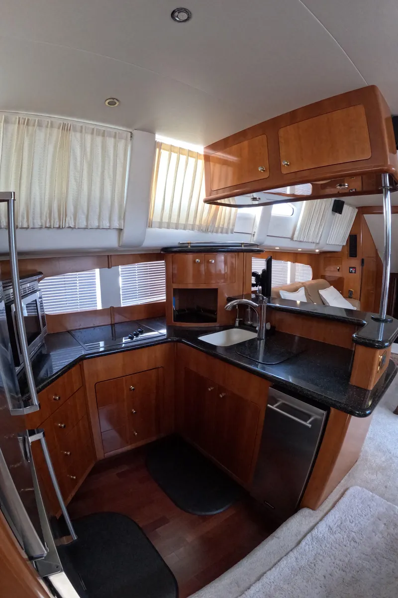 Slide: The Image of Interior kitchen of 2001 Carver 506 Motor Yacht with wooden cabinetry and modern appliances. - 29